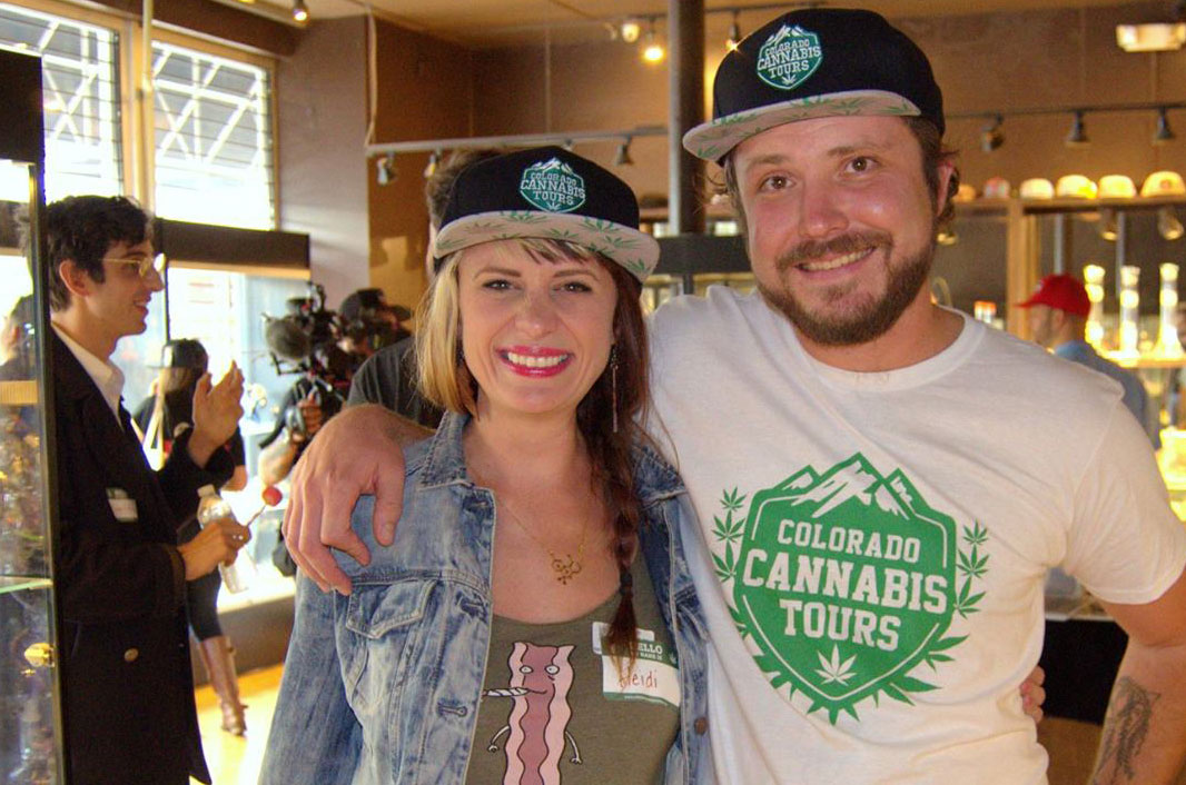 Mike and Heidi wearing the Colorado Cannabis Tours Leaf Logo Hats