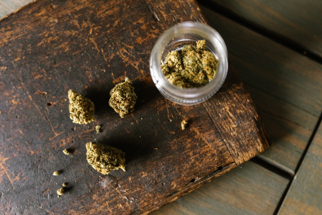 marijuana on a table and in a jar