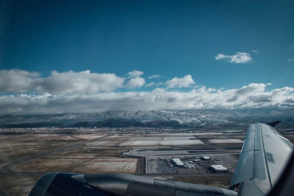 flying into a airport with a view of a mountain