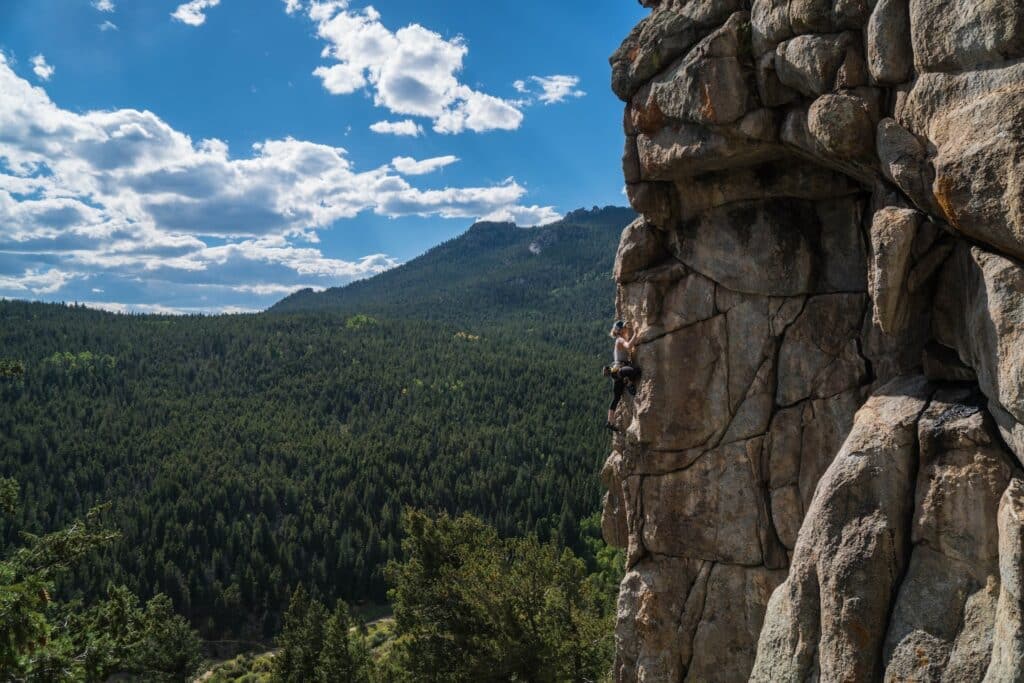 individual midway up at rock wall in Colorado
