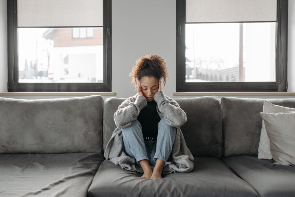 woman sitting on the couch having a marijuana hangover